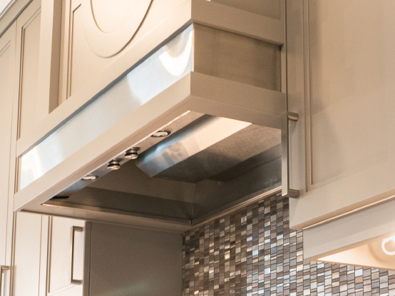 Custom built range hood with integrated vent system.