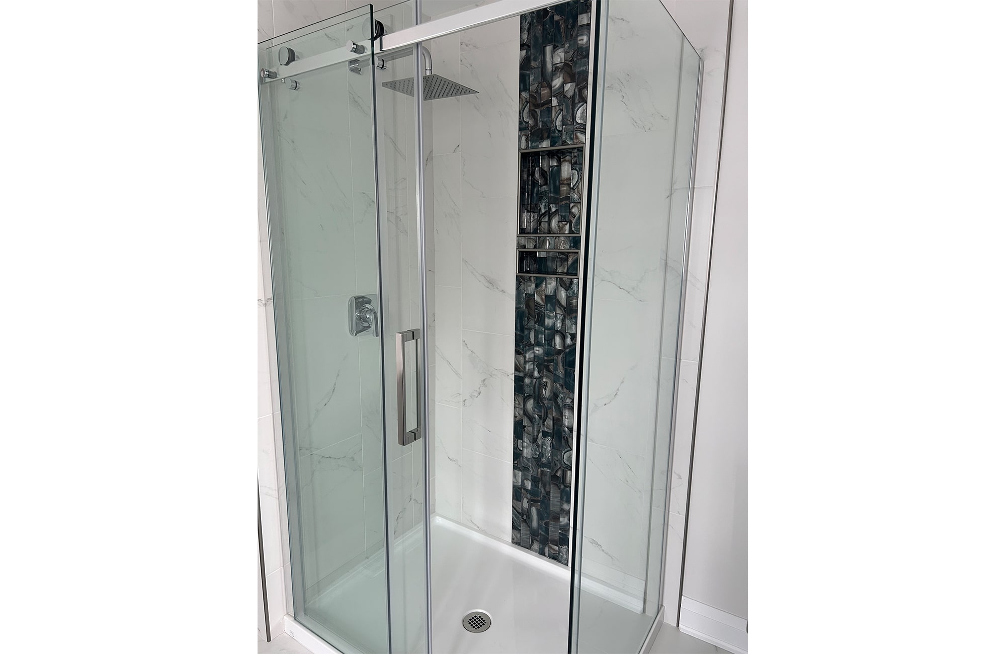 Ensuite shower enclosure with vertical geode tile accent.