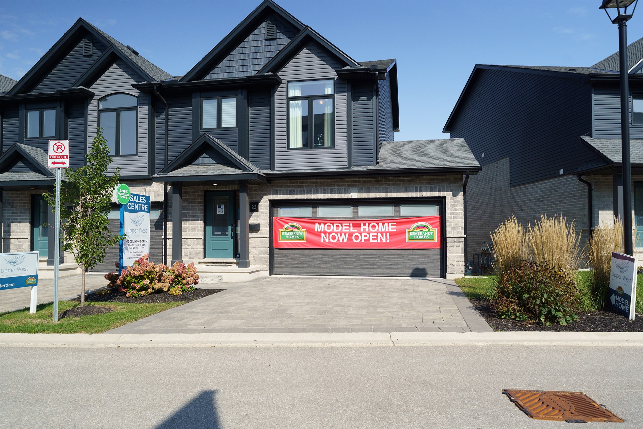 Exterior view of Sales model at Upper West by Rembrandt Homes.